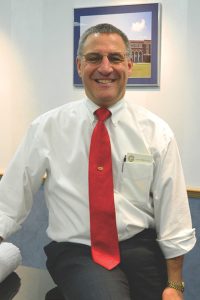 A man in a red tie and white shirt.