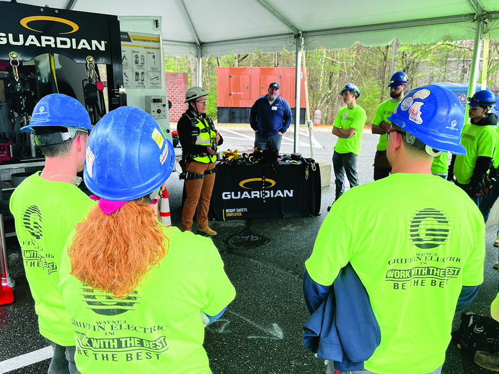 A group of construction workers in hard hats and safety vests.